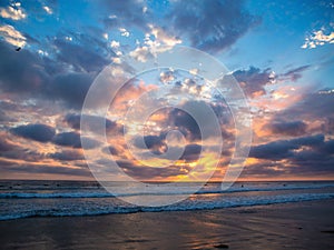 Surfers at sunset