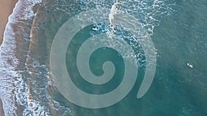 Surfers in the surf waiting for waves in the turquoise ocean off the Victorian Coastline