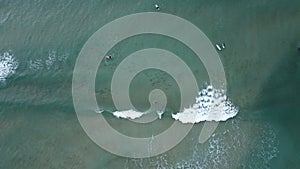 Surfers in the surf waiting for waves in the turquoise ocean off the Victorian Coastline