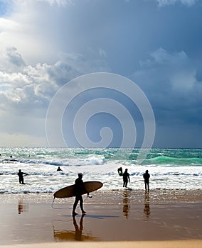 Surfers surfboards beach group Portugal