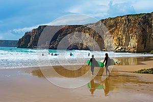 Surfers surfboards beach Portugal cliff