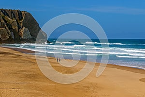 Surfers on the Ursa beach, Portugal - westernmost point of mainland Europe