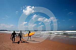 Surfers Walking on the Beach