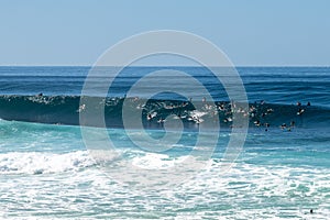 Surfers in the water at Banzai Pipeline beach on North Shore of Oahu