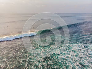 Surfers on the waves in the ocean, top view