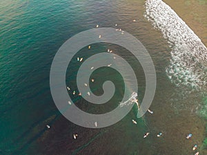 Surfers on the waves in the ocean, top view