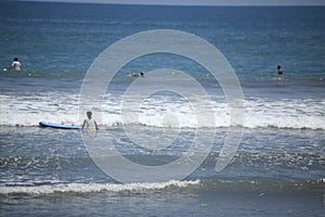 Surfers were waiting for the wave in Kuta Beach Bali Island, Indonesia photo