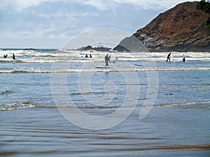 Surfers in Wetsuits Surfing