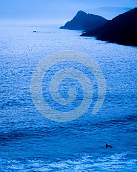 Surfing alone in the immensity of the ocean in France photo