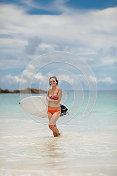 Surfing beautiful woman on the beach