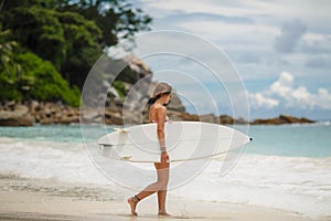 Surfing beautiful woman on the beach