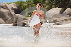 Surfing beautiful woman on the beach