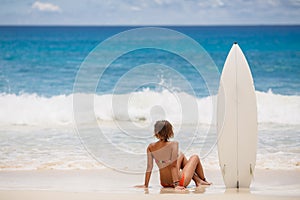 Surfing beautiful woman on the beach photo