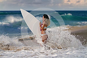 Surfing girl on a beach with white board