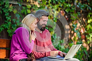 Surfing internet together. Family surfing internet for interesting content. Couple in love notebook consume content photo