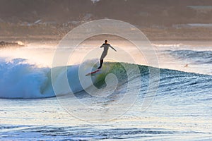 Surfing in Japan, man riding a surfboard in the pacific ocean near Tokyo