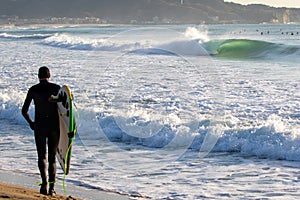 Surfing in Japan, man riding a surfboard in the pacific ocean near Tokyo