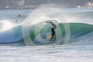 Surfing in Japan, man riding a surfboard in the pacific ocean near Tokyo