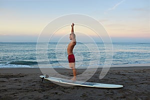 Surfing Man. Stretching Surfer On Sandy Beach Going To Surf On Surfboard.