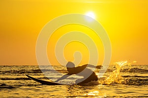 Surfing at Sunset. Outdoor Active Lifestyle. Summer water sport.