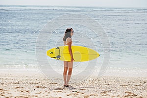 Surfing surfer woman girl walking holding surfboard. Water sport summer vacation travel concept.