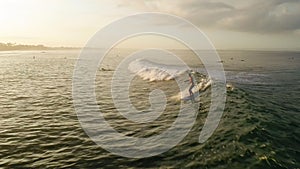 Surfing: Surfer woman riding on the blue waves slow motion