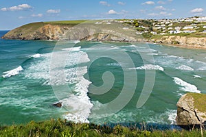 Surfing waves Mawgan Porth beach north Cornwall England near Newquay summer day with blue sky