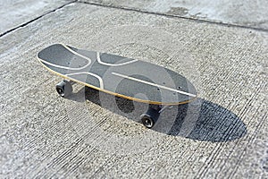 surfskate or skateboard top veiw on concrete road with shadow