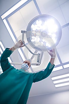 Surgeon adjusting surgical light in operation theater