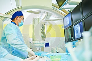 Interventional radiology. surgeon radiologist at operation during catheter based treatment with X-ray visualization. photo