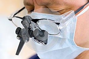 Surgeon with binocular glasses