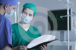 Surgeon consulting patient condition