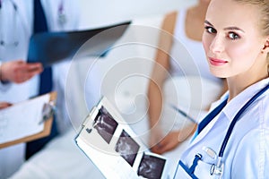 Surgeon and doctor analyzing x-ray together in medical office