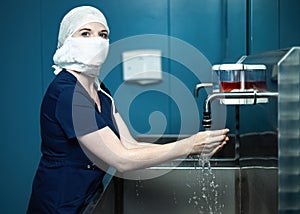 Surgeon doctor disinfects hands before surgery