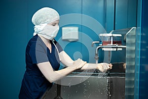 Surgeon doctor disinfects hands before surgery