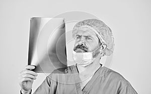 surgeon doctor examines radiographical snapshot. x-raying of vertebra. health problems. nurse checking x-ray film at