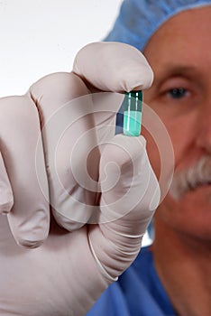 Surgeon holding pill