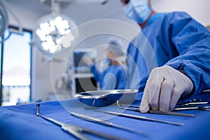 Surgeon holding surgical tool in operation theater photo