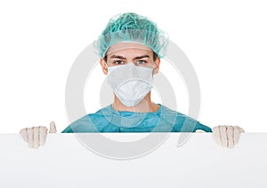 Surgeon holding up a blank banner