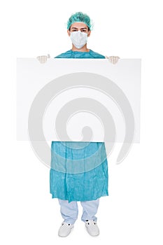 Surgeon holding up a blank banner