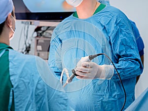 The surgeon holds special medical instruments in his hands during the operation