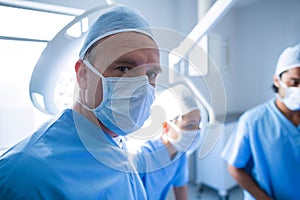 Surgeon looking at camera in operation room