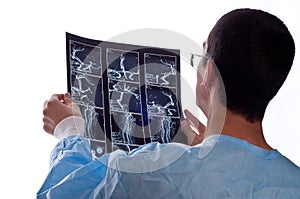 Surgeon looking at CT computer tomography scan image