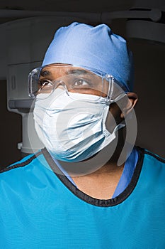 Surgeon in mask and safety goggles