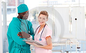 Surgeon and nurse conversing in hospital