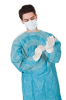 Surgeon putting on surgical gloves