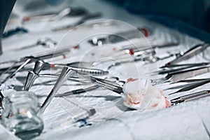 The surgeon`s hands are holding an operating tool in the operating room. Close-up, beautiful light, modern medicine