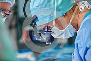 A surgeon`s team in uniform performs an operation on a patient at a cardiac surgery clinic. Modern medicine, a