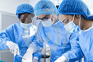 A surgeon`s team in uniform performs an operation on a patient at a cardiac surgery clinic. Modern medicine, a professional team