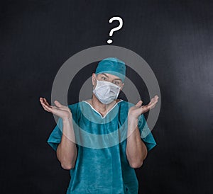 Surgeon in scrubs with an I don`t know gesture.